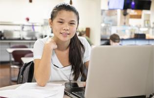 A Woman Sitting in Front of a Laptop